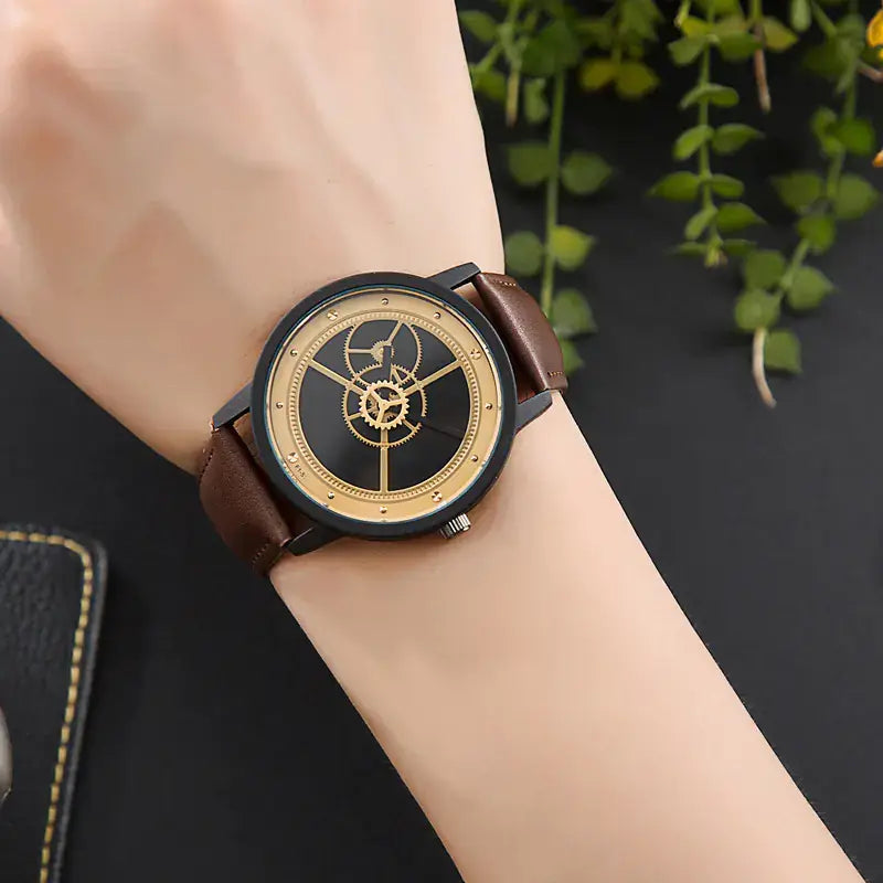 L brand affordable gear watch with black and gold dial and brown leather strap front view
